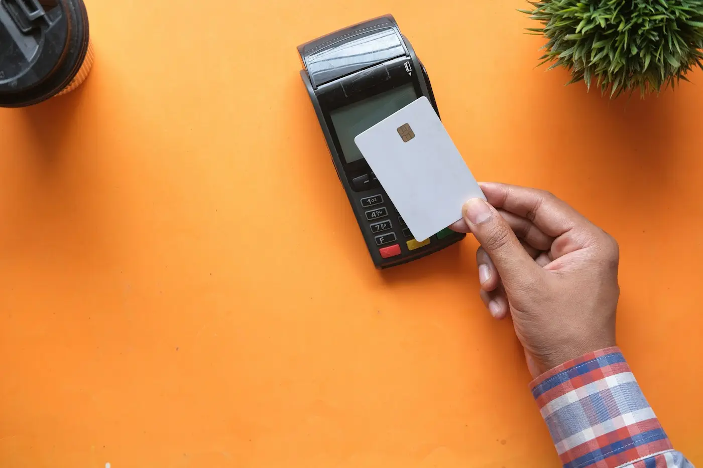Customer tapping to pay at a card terminal (illustrative stock photo)