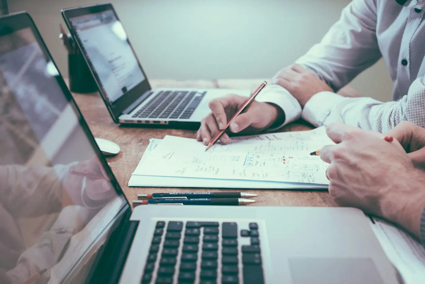 Business owner reviewing invoices on a laptop (illustrative stock photo)