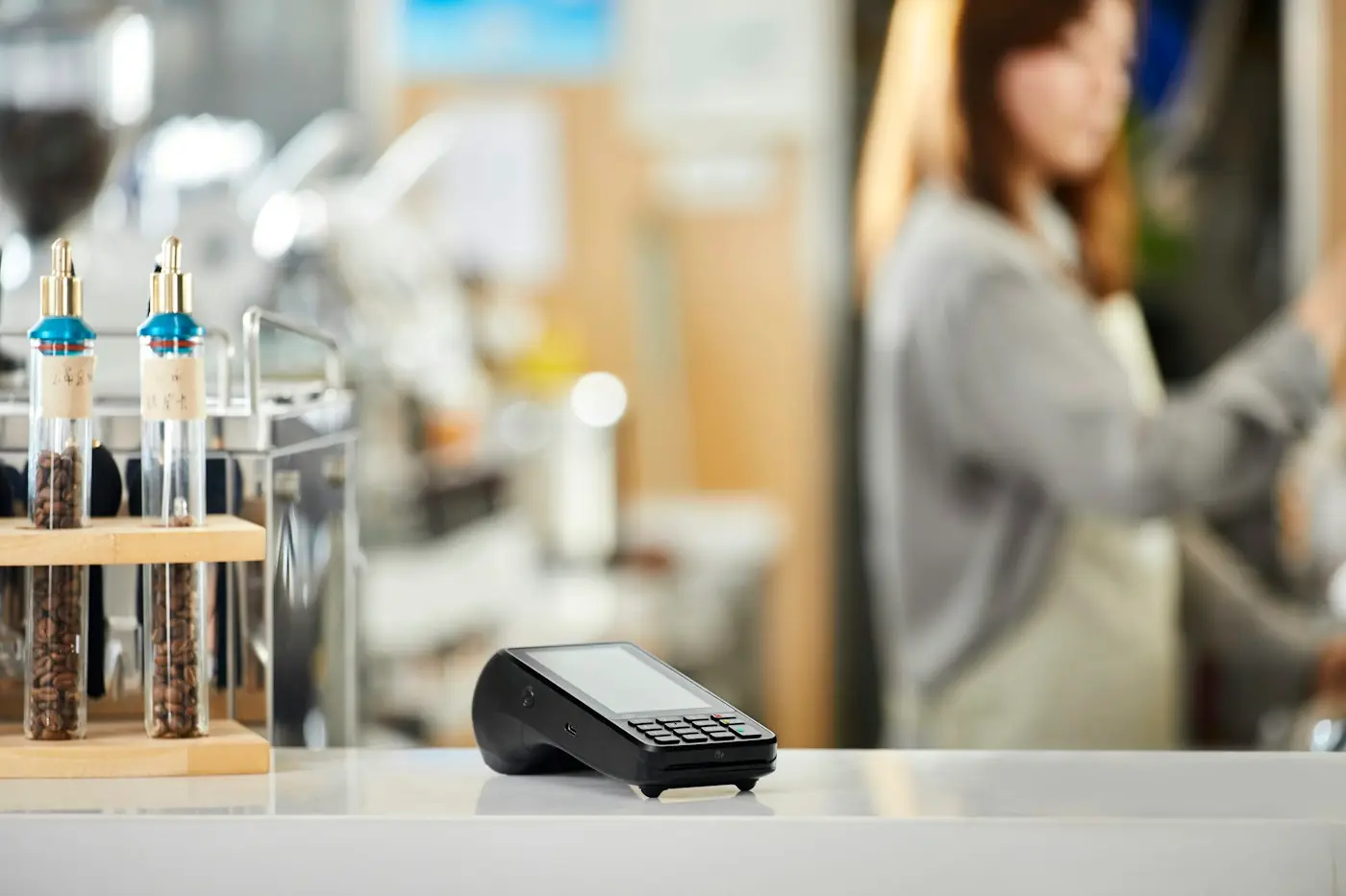Card payment terminal on a shop counter (illustrative stock photo)
