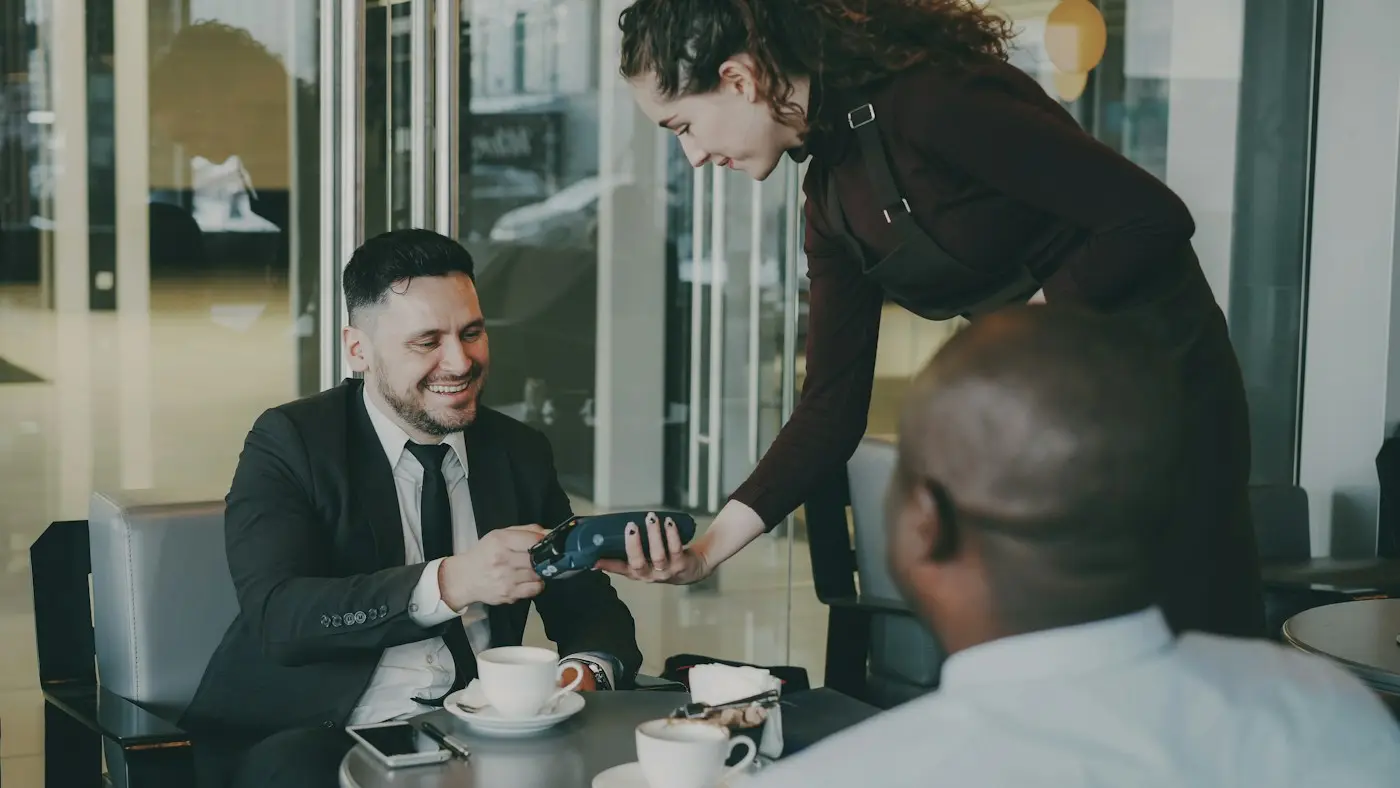Customer paying by card at a café (illustrative stock photo)